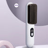 White hair straightening brush with digital display on a light gray background
