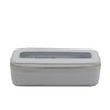 Gray jewelry box with a clear top and gold zipper on a white background